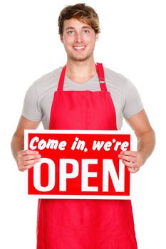 Business owner / employee showing open sign. Man wearing red apron smiling happy. Caucasian male model.