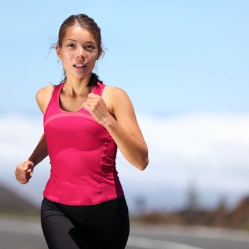 runner - woman running outdoors training for marathon run. Beautiful fit asian fitness model in her 20s.