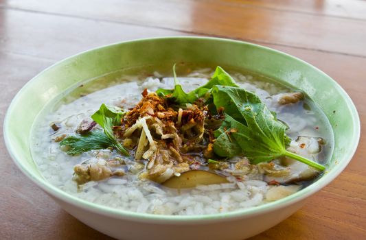 Asian style rice soup with herbs in a bowl