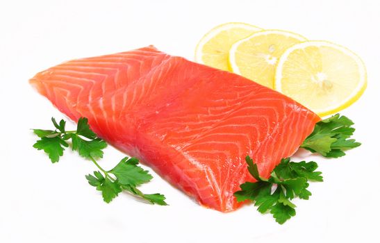 Salmon steak with lemon slices and parsley isolated on white background 