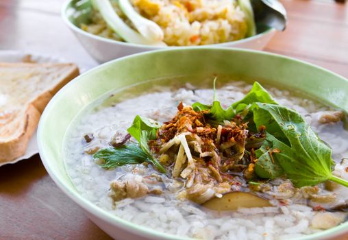 Asian style rice soup with herbs in a bowl