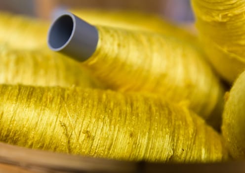 Sewing threads golden color  closeup