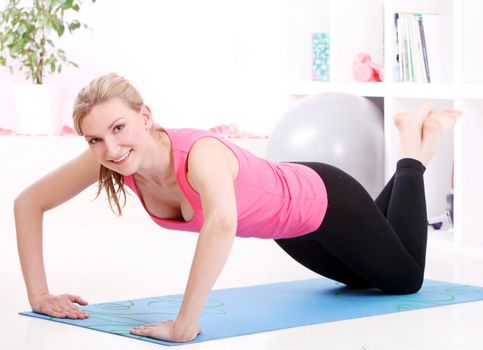 Young beautiful woman working out at home