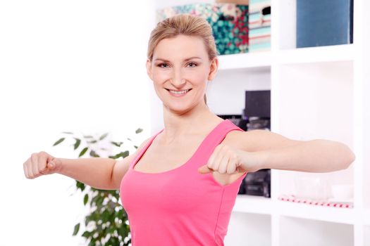 Young beautiful woman working out at home