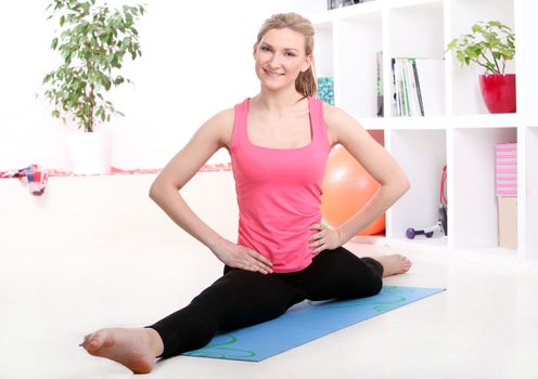 Young beautiful woman working out at home