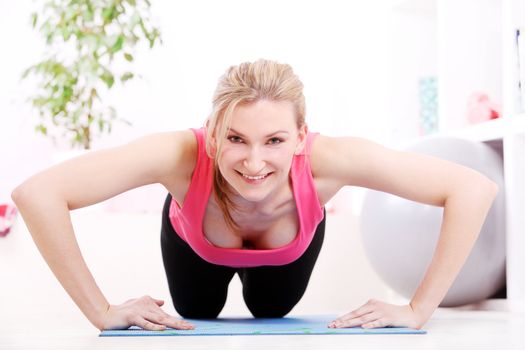 Young beautiful woman working out at home