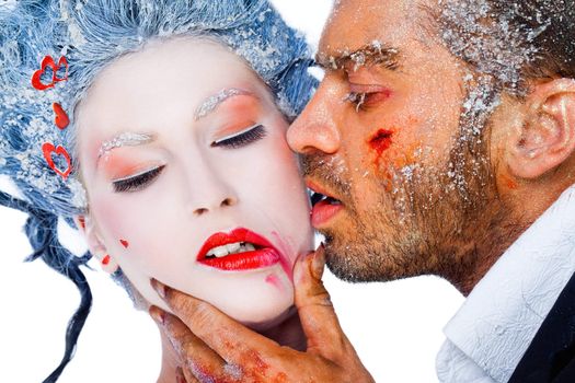 Male kissing female on cheek, smudging her lipstick - both faces with frozen makeup
