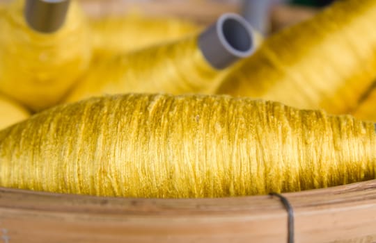 Sewing threads golden color  in basket