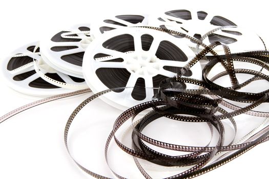 Obsolete rolls of old 8mm movie film are wound on white plastic reels.