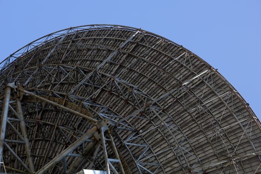 large radio telescope antenna on blue sky