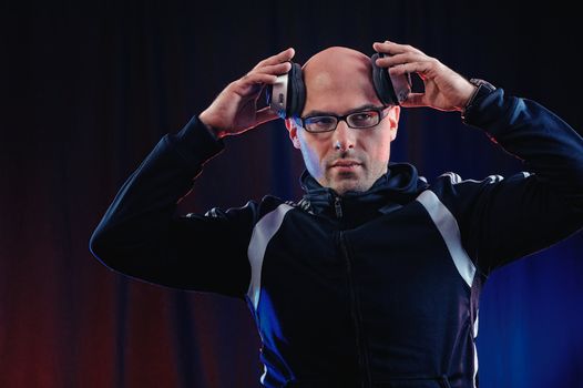 Man in glasses wearing headphones in the studio