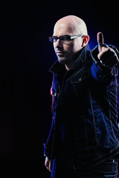 Man with glasses and in denim jacket. Studio-style portrait