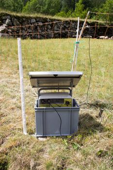 Solar energy panel with electric fence in Swiss Alps