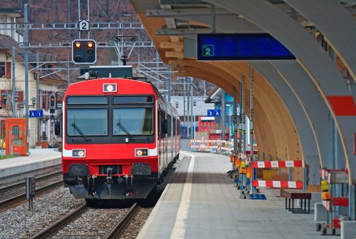 Red Train coming to Interlaken Station Switzerland