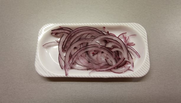 red   onions  on  a  platter   on a  gray  background
