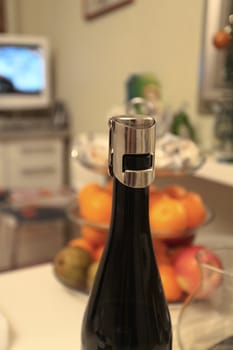 bottle of wine against the bowl of fruit