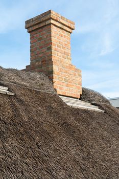 Traditional country house with old style thatched straw roof 