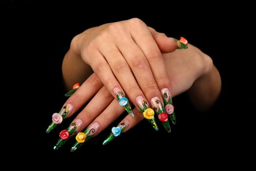 Human fingers with long fingernail and beautiful manicure isolated on black