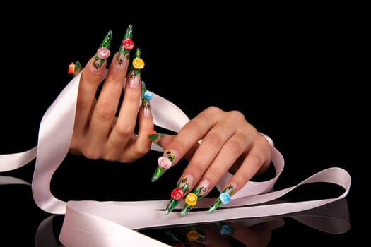 Human fingers with long fingernail and beautiful manicure isolated on black