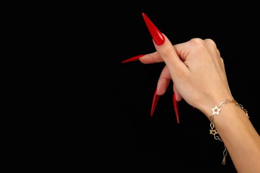 Human fingers with long fingernail and beautiful manicure isolated on black