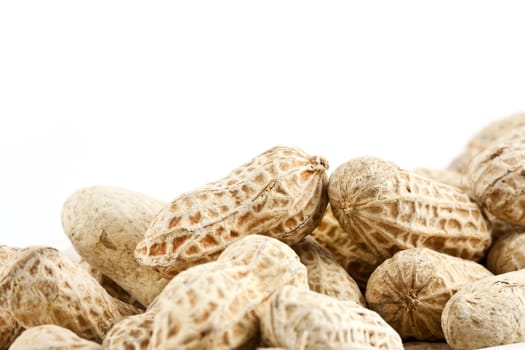 Peanut in shell snack on white plate - shallow DOF focus in the middle