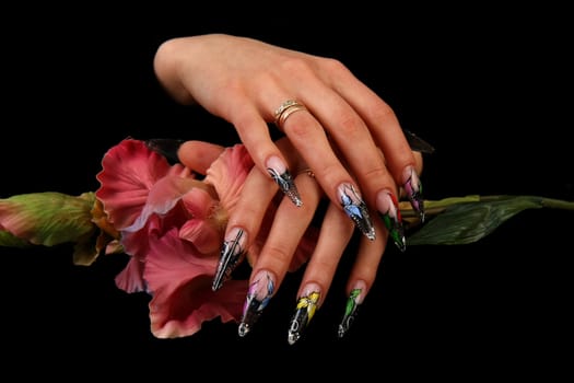 Human fingers with long fingernail and beautiful manicure isolated on black