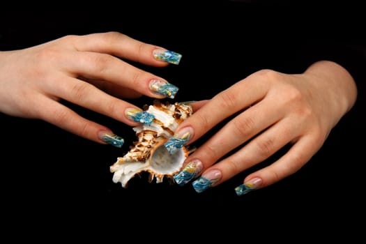 Human fingers with long fingernail and beautiful manicure isolated on black