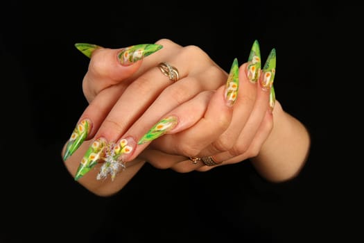 Human fingers with long fingernail and beautiful manicure isolated on black