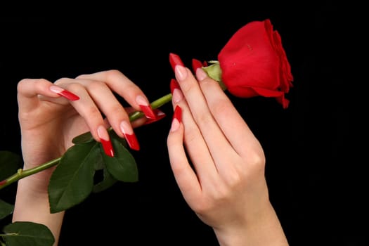 Human fingers with long fingernail and beautiful manicure isolated on black