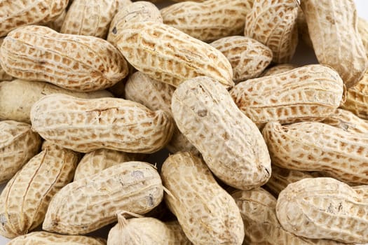 Background of roasted peanuts in shell