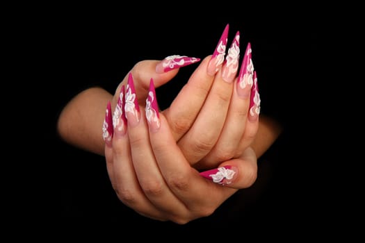 Human fingers with long fingernail and beautiful manicure isolated on black