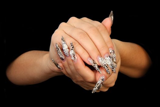 Human fingers with long fingernail and beautiful manicure isolated on black