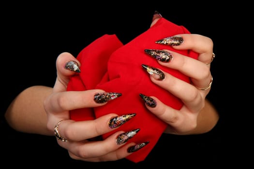 Human fingers with long fingernail and beautiful manicure isolated on black