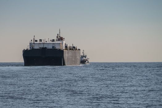 Tug boat towing barge off the coast of Oxnard, California