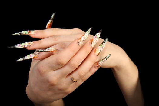 Human fingers with long fingernail and beautiful manicure isolated on black