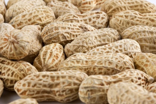 Background of roasted peanuts in shell - shallow DOF, focus in the middle.
