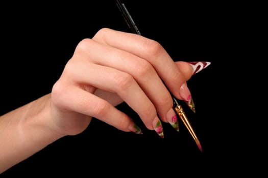 Human fingers with long fingernail and beautiful manicure isolated on black