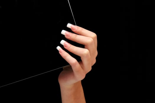 Human fingers with long fingernail and beautiful manicure isolated on black