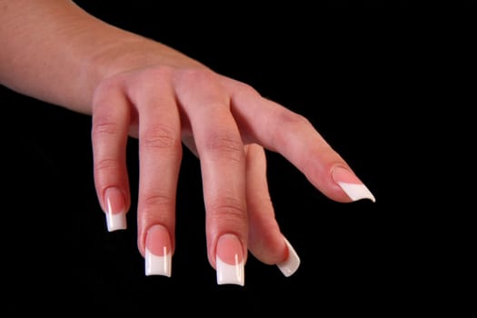 Human fingers with long fingernail and beautiful manicure isolated on black