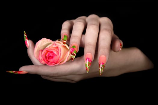 Human fingers with long fingernail and beautiful manicure isolated on black