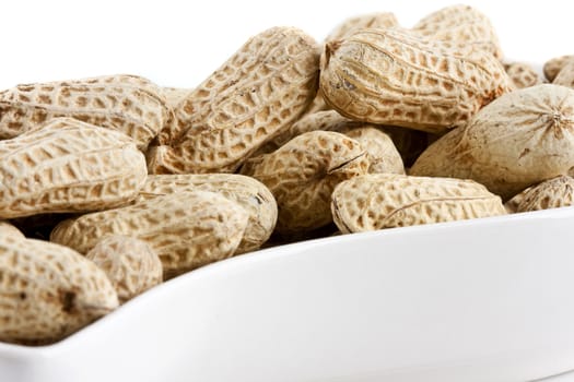 Peanut in shell snack on white plate