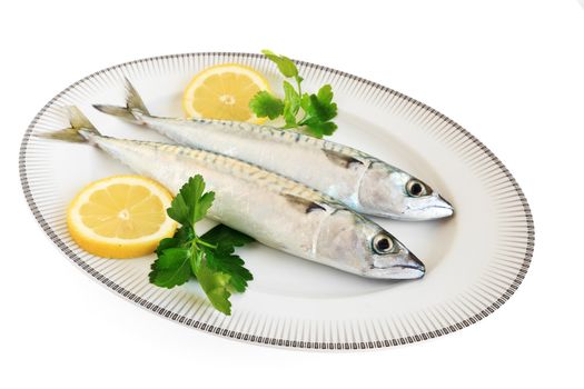 dish with two mackerels with lemon and pasley isolated on white background with clipping path