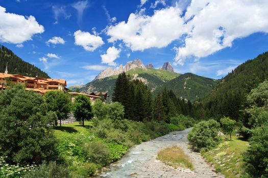 summer view of Avisio river in Fassa Valley, Trentino, Italy
