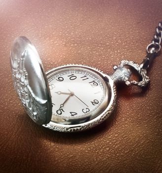 Close up of a pocket watch on brown texture