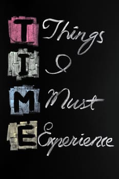 TIME acronym written with colorful chalk on blackboard
