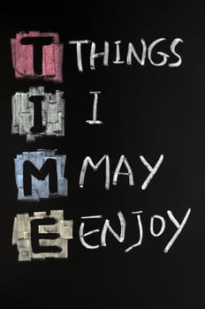 TIME acronym written with colorful chalk on blackboard