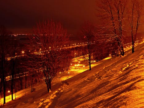 Winter morning landscape with orange light from some lanterns