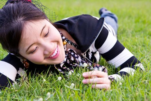 Asian woman relaxed on the grass