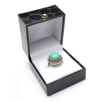 Round turquoise cabachon ring with marcasite in gift box. Isolated on white background.