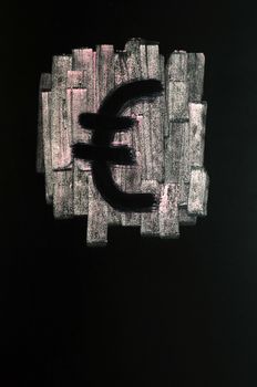 Symbol of Euro drawn with chalk on blackboard, with a check box